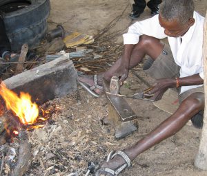 Tembedza pounding red hot steel to make mbira key
